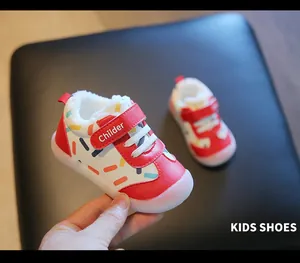 Close-up detail of fleece-lined warm winter toddler shoes featuring a red velcro strap.