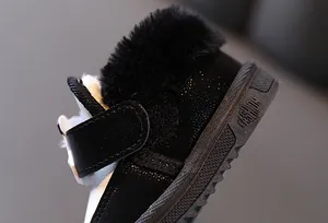 Macro close-up showing the soft black faux fur lining of winter warm toddler snow boots