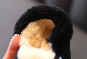 Close-up detail of thick warm white faux fur lining inside winter snow boots for toddlers