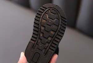 Close-up detail of non-slip rubber sole with deep tread pattern on baby winter snow boot