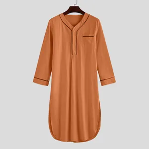 Men's long sleeve kaftan loungewear in orange with black piping detail