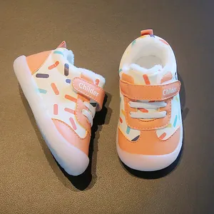 Warm winter toddler shoes with fleece lining and colorful patterns on white leather