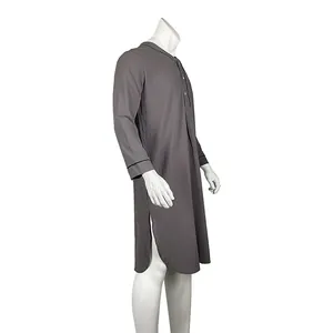 Side view of a grey long-sleeved men's nightshirt with black piping and side slits.