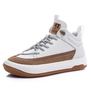 Side view detail of white leather high-top sneakers with brown accents and gum sole