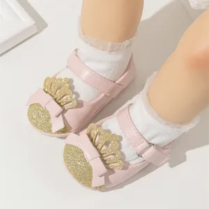 Detailed view of pink baby girl princess walking shoes featuring glitter crown and bow