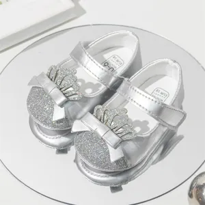 Close-up of silver sequin princess baby shoes with crown decoration and soft sole