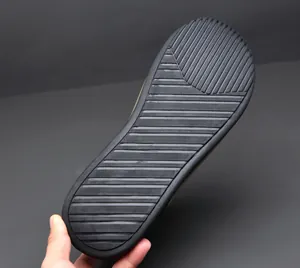 Detailed view of black rubber sole with anti-slip stripe pattern for high-top sneakers.