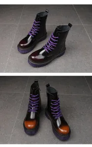 Detailed view of women's black and gradient orange platform Martin boots with purple laces
