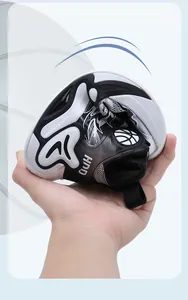 Flexible black and white boys basketball shoe with leather upper showing high durability.