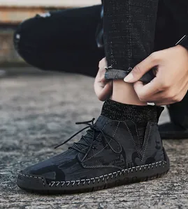 Detailed view of men's black mid-top casual shoes with unique graphic print and knit collar