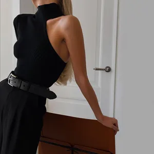 Close-up of black one-shoulder knit bodysuit with chic high neck and ribbed texture.