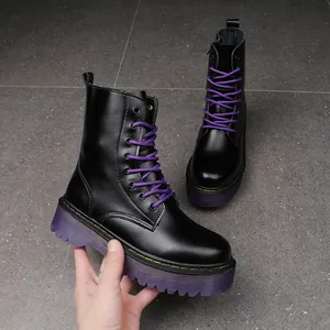 Women's black platform Martin boots with vibrant purple laces and chunky purple sole