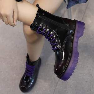 Chic black patent leather platform boots with vibrant purple laces and translucent sole