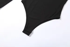 Close-up detail of black ribbed bodysuit showing crotch snap button closure