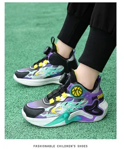 Close-up of stylish purple and black boys basketball shoes on green court surface.