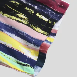 Macro view of colorful paint-stroke striped short sleeve shirt with white stitching detail