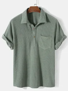 Detail view of a sage green men's short-sleeved shirt with a premium waffle grid texture