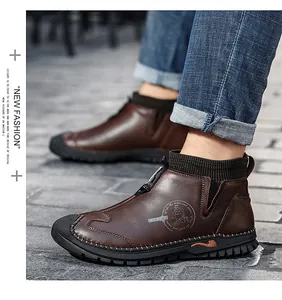 Close-up of brown leather mid-top boots with ribbed sock collar and zipper detail