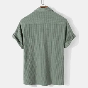 Back view of a sage green men's casual short sleeve shirt featuring waffle knit texture