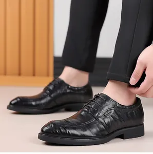 Detailed macro view of black sheepskin leather texture on men's business dress shoes.