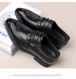 Close-up detail of black genuine leather business shoes on a white decorative box
