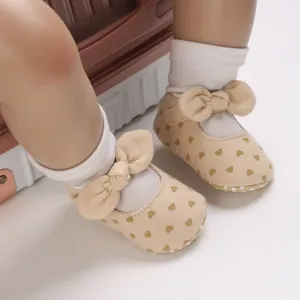 Detail view of baby girl cotton walking shoes with lovely heart pattern and bow decoration