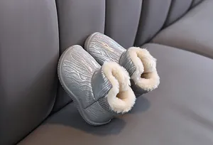 Detail view of shimmering silver children's snow boots with plush faux fur lining