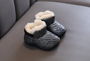 Warm children's snow boots featuring silver wave patterns and thick cream plush lining