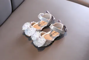 Elegant silver glitter girl's princess sandals with rhinestone bow and soft sole detail