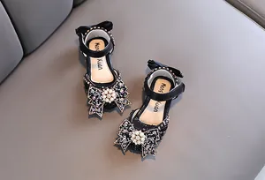 Elegant black girl's princess sandals with sparkling rhinestone and pearl bow detail