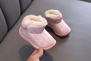 Close-up of pink glittery children's snow boots with thick warm faux fur lining.