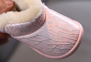 Close-up of pink glittery children's snow boot with thick warm fleece lining