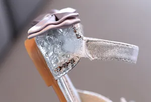 Detailed macro view showing sparkling rhinestones and satin bow on girl's princess sandal