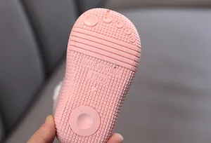 Macro detail view of the pink anti-slip rubber sole for children's winter warm snow boots