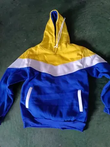 Detail view of a yellow, white, and blue color-block hoodie with drawstring cords.