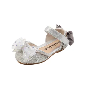 Elegant silver girls princess sandals featuring a large sparkling rhinestone bow design