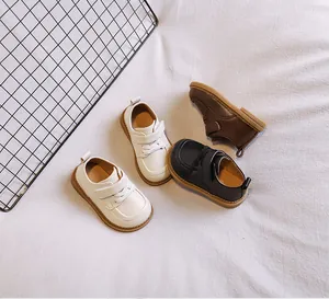 Toddler soft-soled leather shoes displayed in white, black, and brown colors