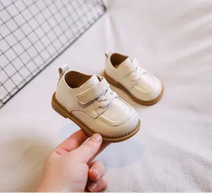 Soft-soled cream toddler leather shoes for baby girls walking support in detail view