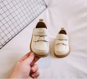 Detailed view of cream soft sole baby leather shoes with convenient velcro strap for toddlers