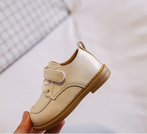 Side view of premium cream baby girl soft sole leather shoes with secure velcro strap