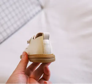 Macro detail showing the durable soft sole and heel design of baby cream leather shoes