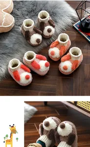 Close-up view of cute cartoon dog plush slippers for kids in brown, pink, and orange