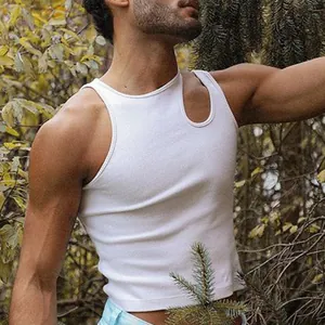 Men's white slim fit tank top with asymmetric cutout neckline in an outdoor setting