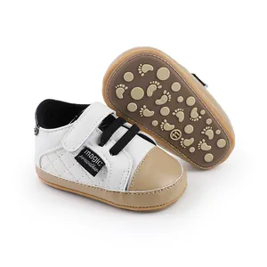 Close-up of white and beige baby walker shoes with anti-slip footprint soles