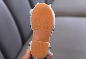 Close-up of non-slip rubber sole for girls' rhinestone sandals, showing size 23 detail.