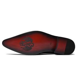 Close-up detail of the artistic red patina sole of a pointed formal men's dress shoe