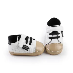 Detail shot of infant pre-walker shoes featuring a stylish white and tan color block design.