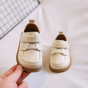 Elegant cream-colored soft-sole baby leather shoes designed for toddler girls learning to walk