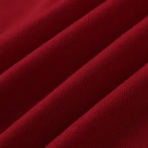 Close-up of soft red knitted fabric texture with elegant folds for men's vest