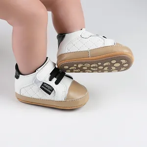 Detail of baby walking shoes with white quilted texture and soft tan rubber soles